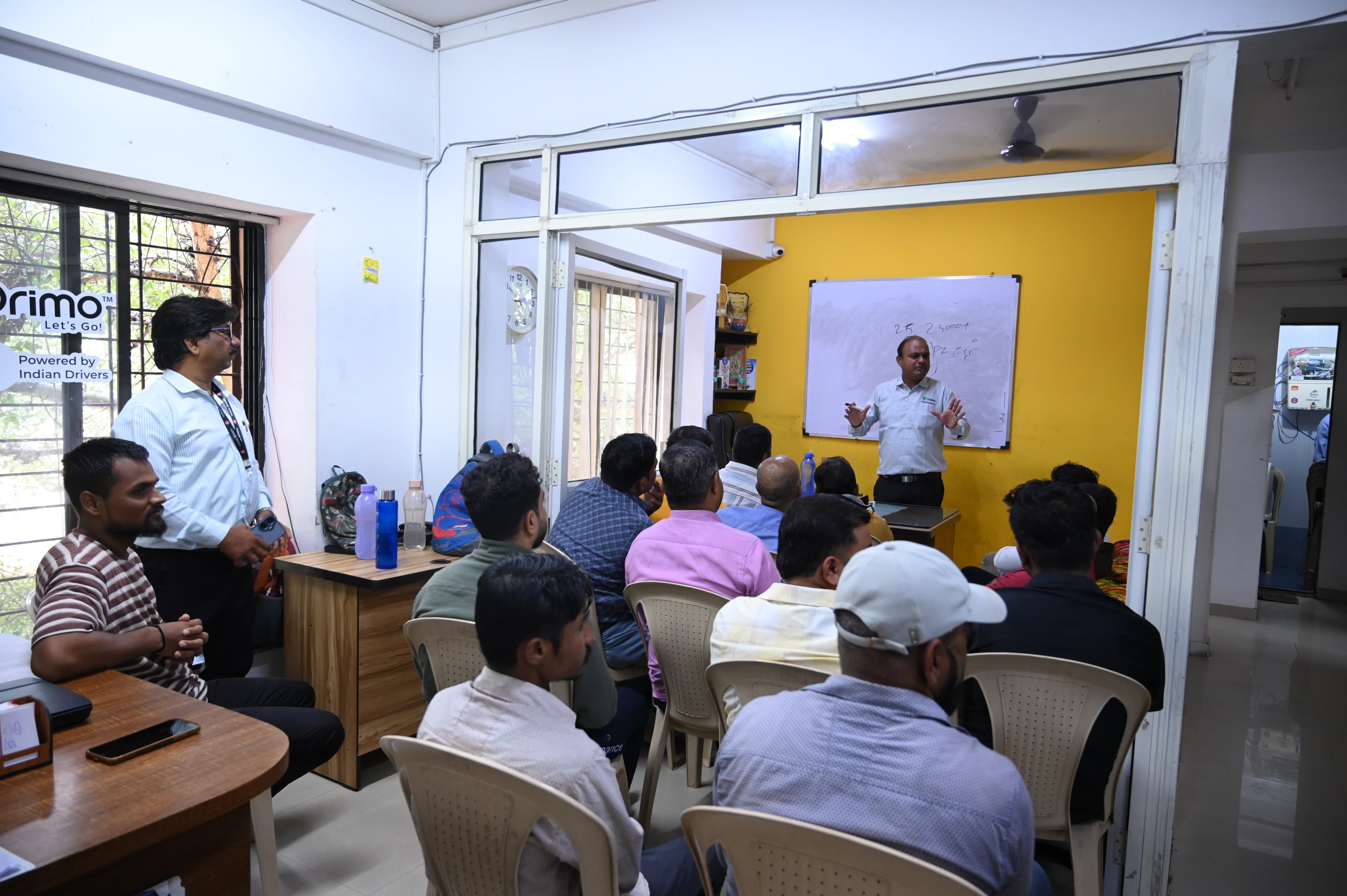 Driver training session with instructor at whiteboard